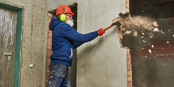 Man demolishing a wall